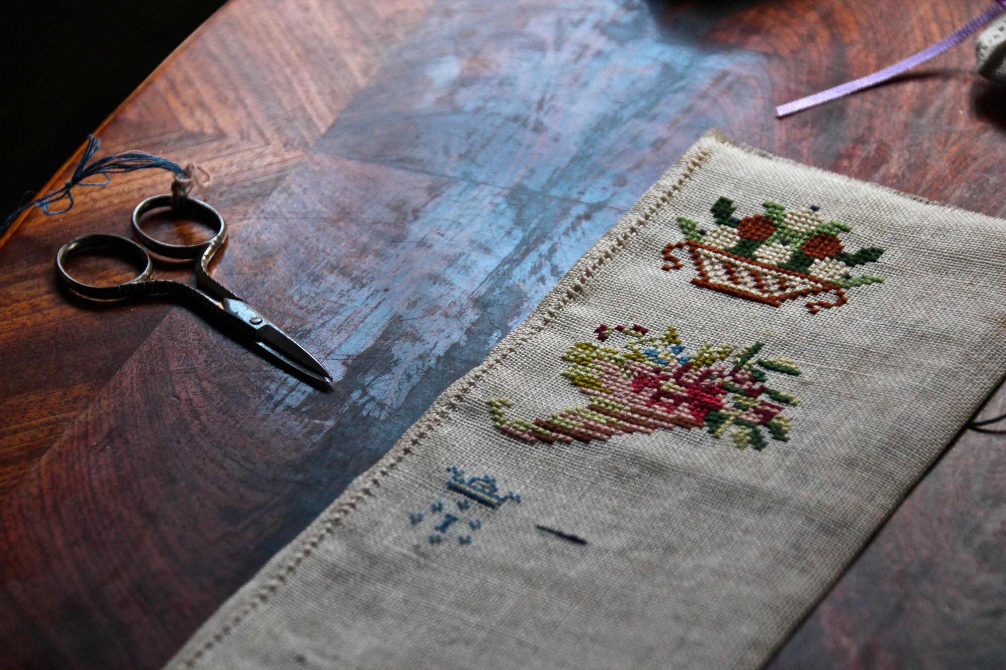 restoration of antique embroidered cloth on frame